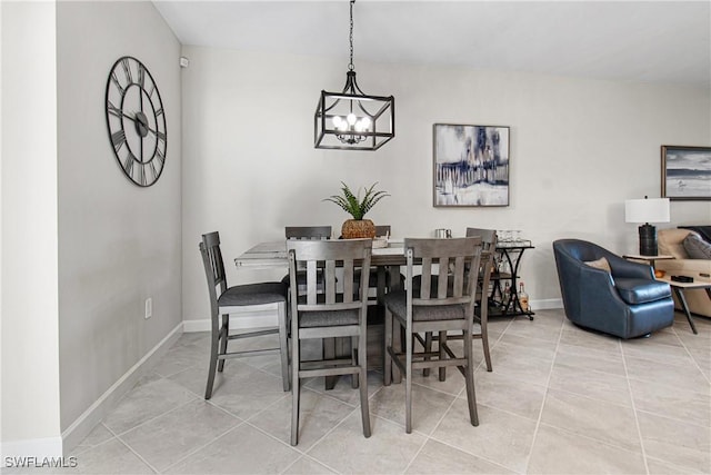 tiled dining room with an inviting chandelier