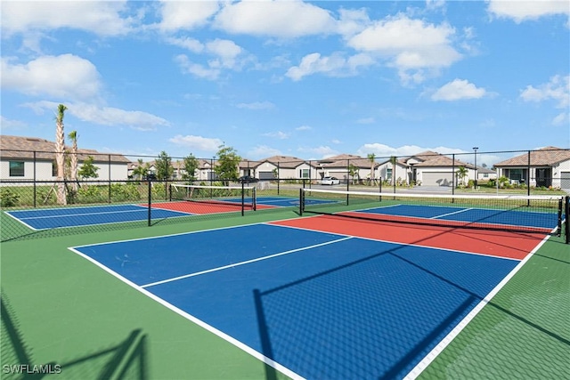 view of tennis court with basketball hoop