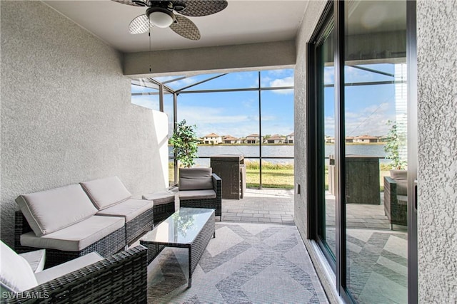 sunroom featuring ceiling fan