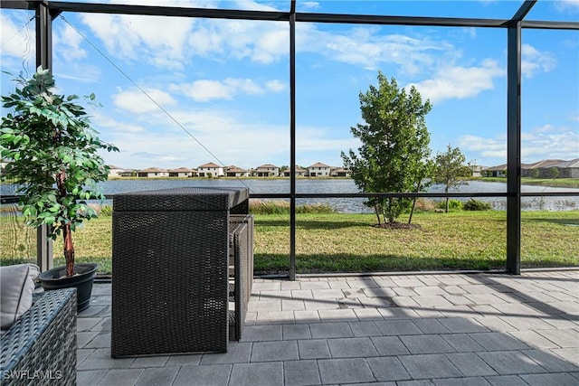 unfurnished sunroom featuring a water view and a healthy amount of sunlight