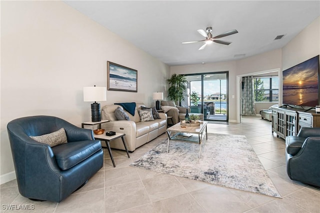 tiled living room with ceiling fan