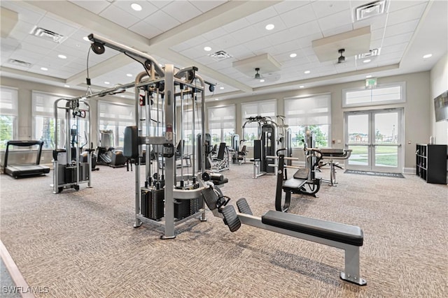 workout area featuring carpet, a drop ceiling, and a towering ceiling