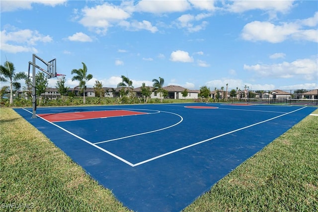 view of basketball court with a yard