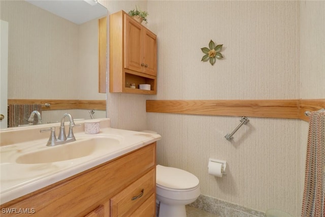 bathroom featuring toilet and vanity