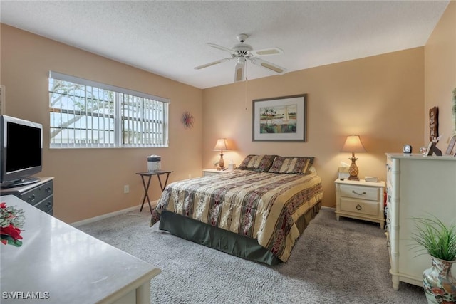 carpeted bedroom with ceiling fan and a textured ceiling