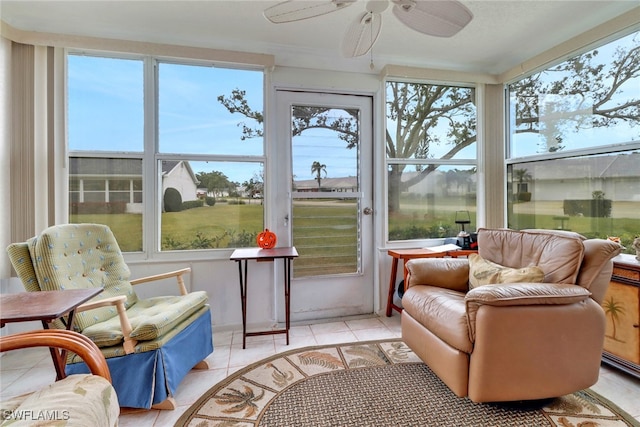 sunroom featuring ceiling fan and plenty of natural light