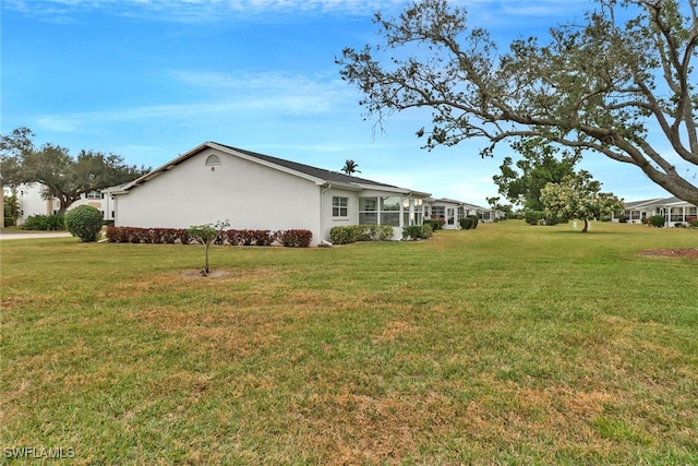 view of side of property featuring a lawn