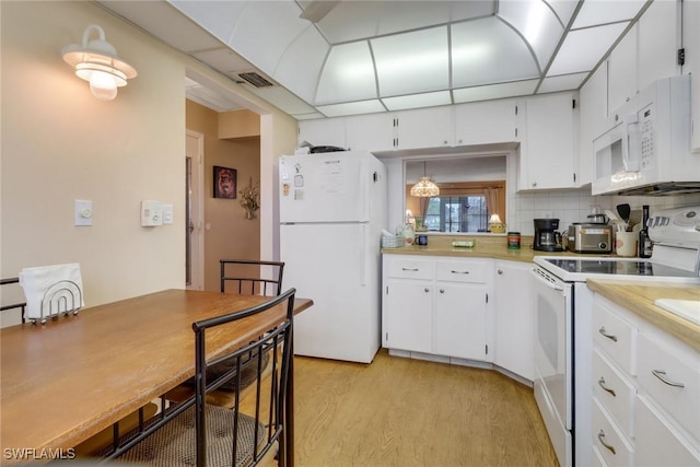 kitchen featuring white cabinetry, decorative backsplash, white appliances, light wood-type flooring, and pendant lighting