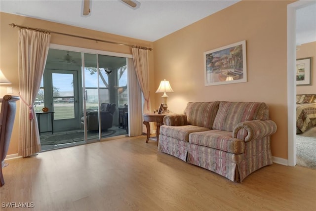 living room featuring ceiling fan and hardwood / wood-style floors