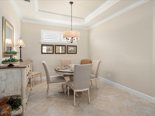 dining room with a chandelier, crown molding, and a raised ceiling