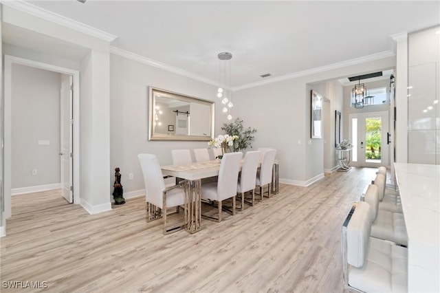 dining area with french doors, ornamental molding, light hardwood / wood-style floors, and a notable chandelier