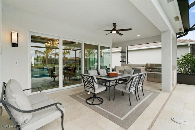 exterior space featuring a grill, sink, ceiling fan, and exterior kitchen