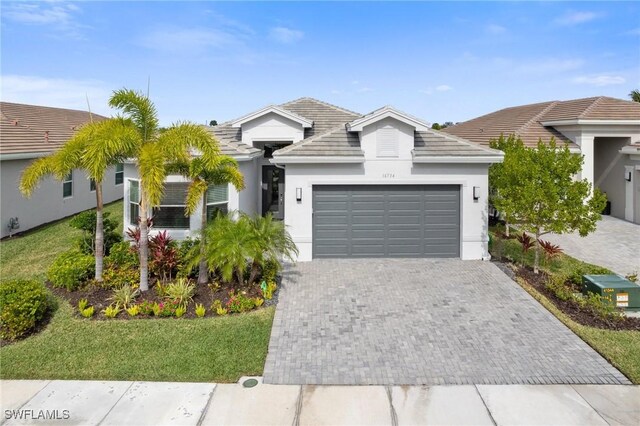 view of front of property featuring a garage and a front lawn