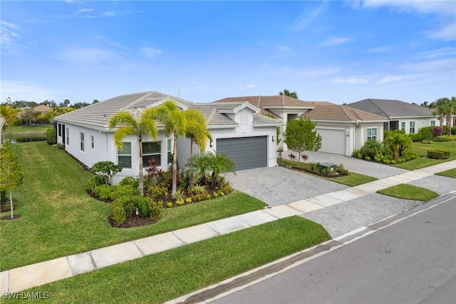 ranch-style home featuring a garage and a front yard