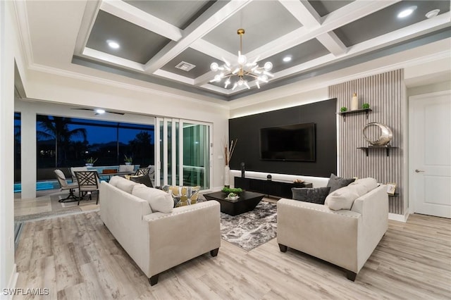 living room with coffered ceiling, a notable chandelier, and light wood-type flooring