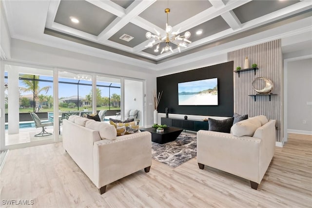 living room with an inviting chandelier, ornamental molding, coffered ceiling, and light hardwood / wood-style flooring