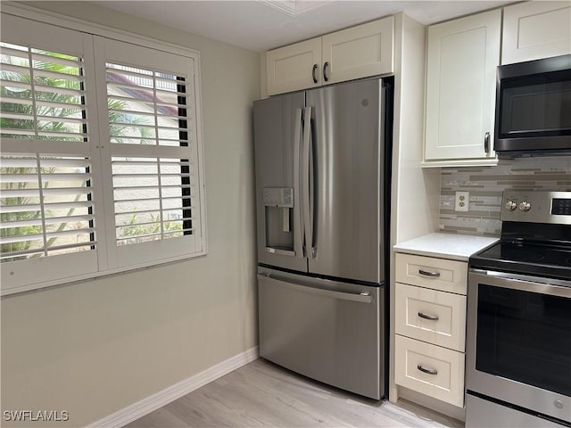 kitchen with stainless steel appliances and white cabinetry