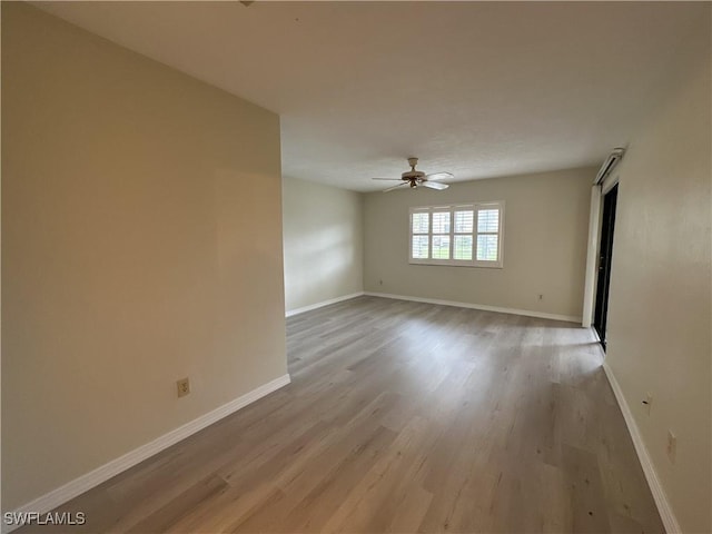 spare room featuring ceiling fan and light wood-type flooring