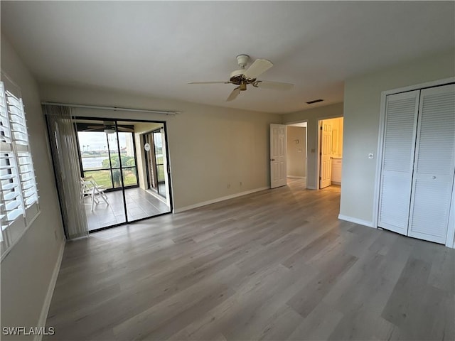 unfurnished bedroom featuring a closet, light hardwood / wood-style floors, access to outside, and ceiling fan