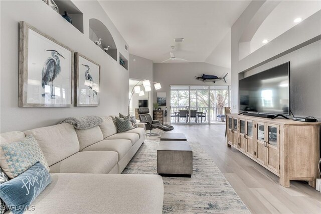 living room featuring light hardwood / wood-style floors and vaulted ceiling