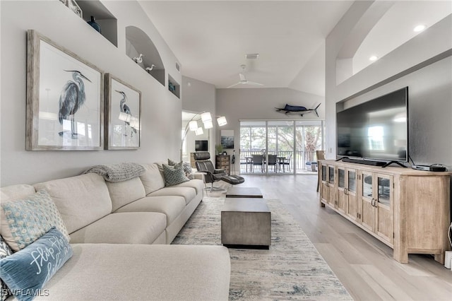 living room with lofted ceiling and light hardwood / wood-style floors