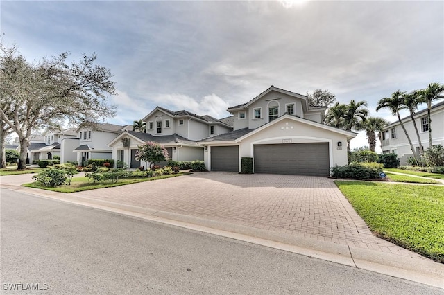 view of front of house with a garage and a front yard