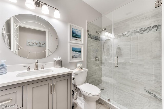 bathroom with vanity, toilet, and an enclosed shower