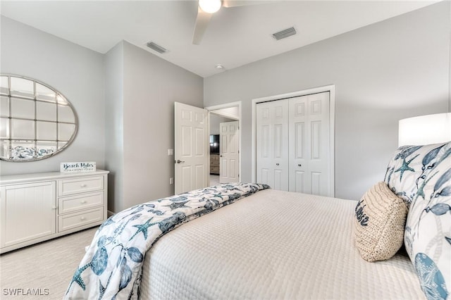 carpeted bedroom with ceiling fan and a closet