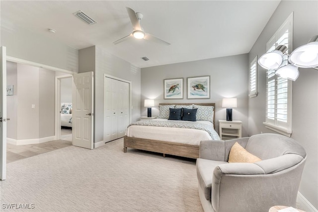 carpeted bedroom with a closet and ceiling fan