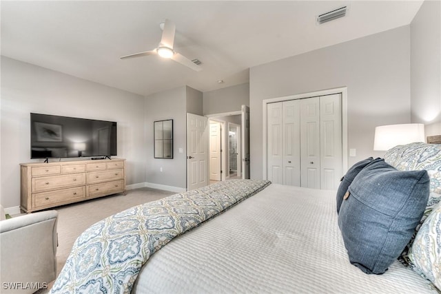 bedroom featuring ceiling fan, light carpet, and a closet