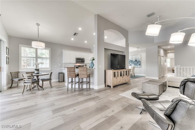 9181 Palmetto Ridge Dr Unit 202, Estero, FL 34135 - living area featuring light wood-type flooring, vaulted ceiling, and recessed lighting