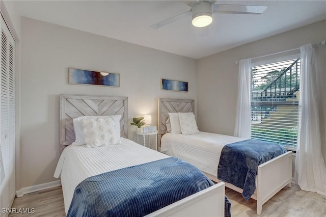 bedroom featuring ceiling fan, a closet, and light hardwood / wood-style floors