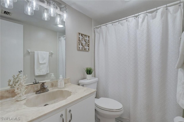 bathroom featuring toilet and vanity