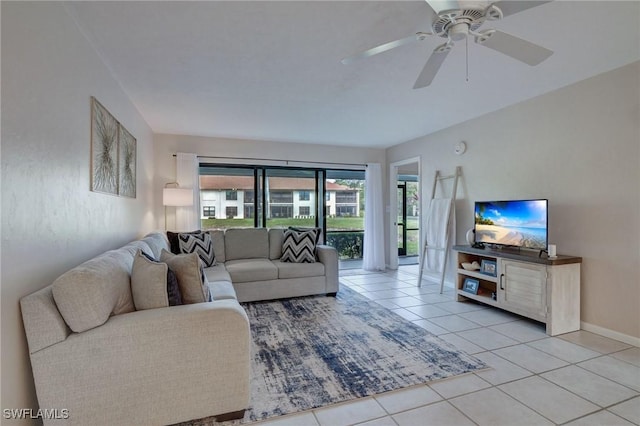 living room with ceiling fan and light tile patterned flooring