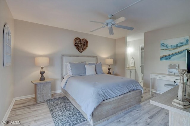 bedroom featuring ceiling fan, ensuite bathroom, and light hardwood / wood-style flooring