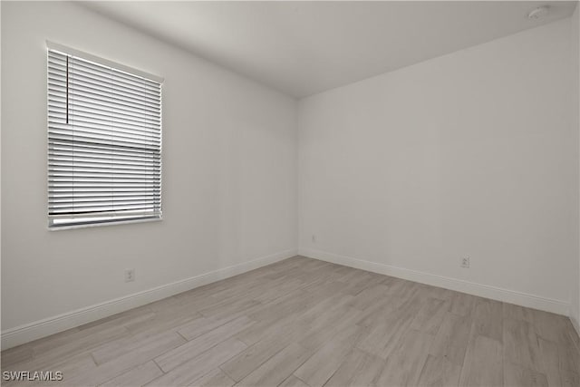 spare room with light hardwood / wood-style flooring