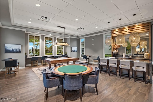 game room with hardwood / wood-style flooring, ornamental molding, billiards, and a tray ceiling