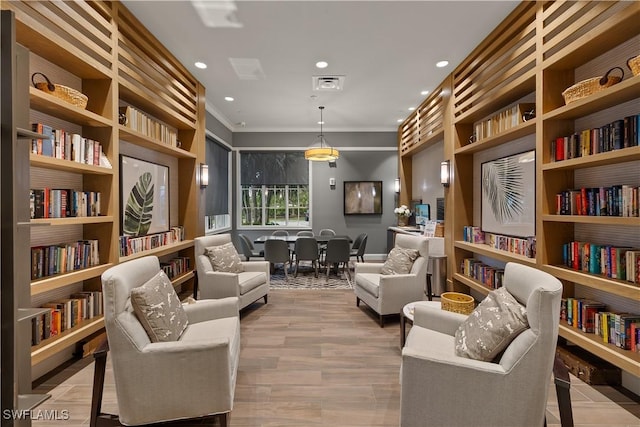 living area with crown molding