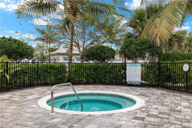 view of swimming pool with a hot tub