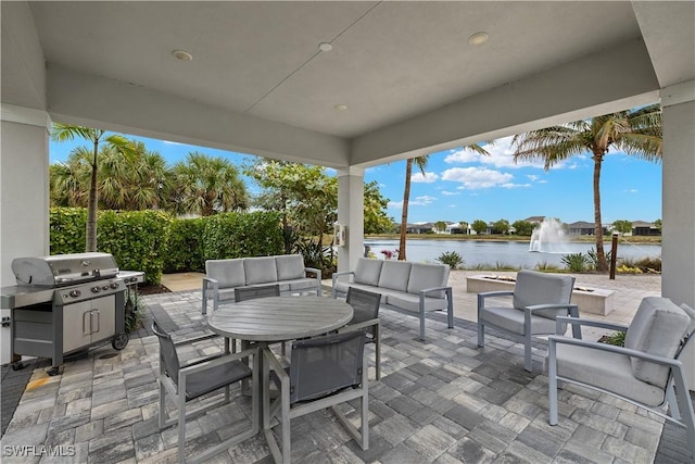 view of patio / terrace featuring a water view, grilling area, and outdoor lounge area