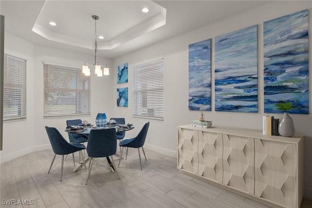 dining room featuring a chandelier, crown molding, and a raised ceiling