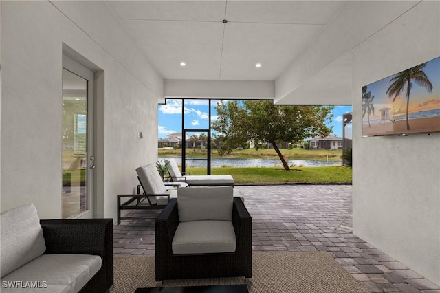 sunroom / solarium with a water view