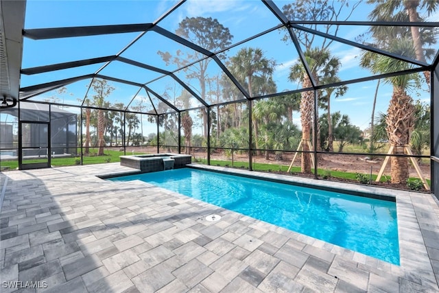 view of swimming pool featuring glass enclosure, an in ground hot tub, and a patio