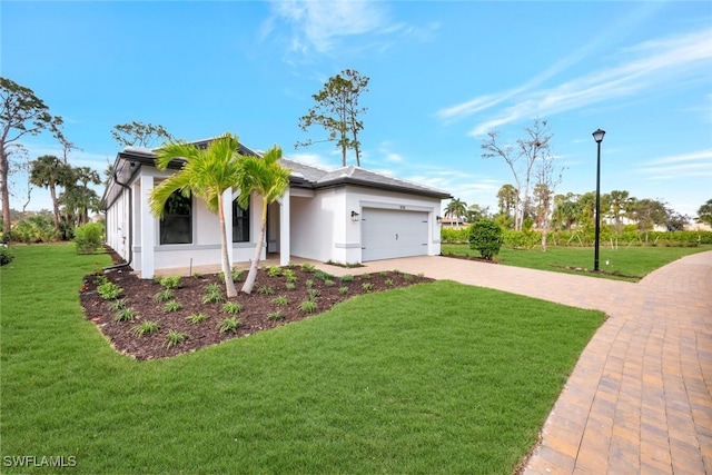 view of front of property featuring a garage and a front yard