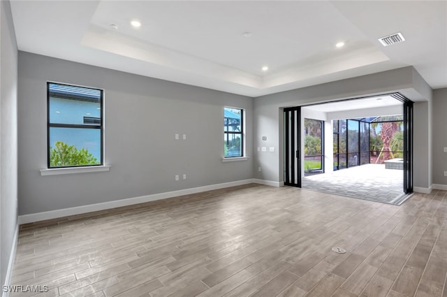 spare room featuring a raised ceiling