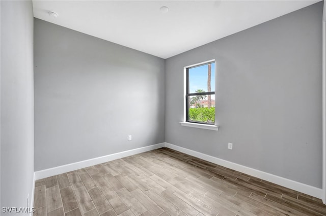 spare room with light hardwood / wood-style flooring