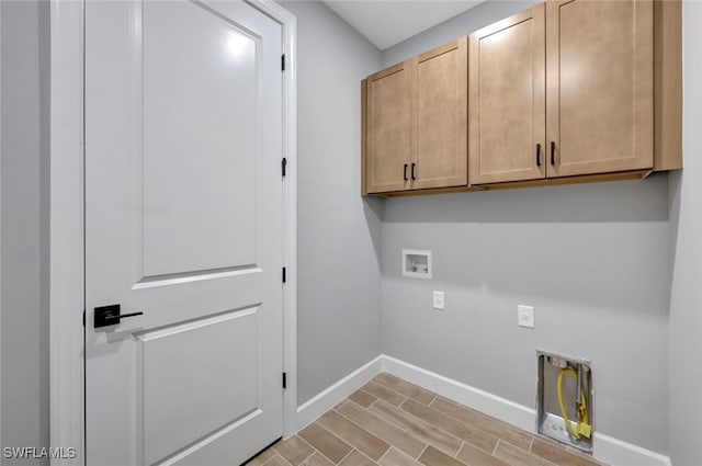 clothes washing area featuring light wood-type flooring, cabinets, hookup for a washing machine, and hookup for an electric dryer