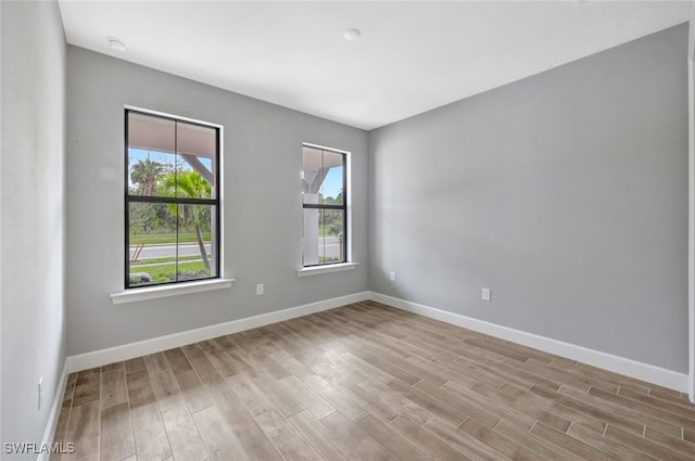 spare room with light hardwood / wood-style flooring