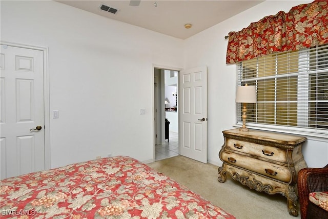 bedroom featuring ceiling fan, visible vents, and carpet flooring