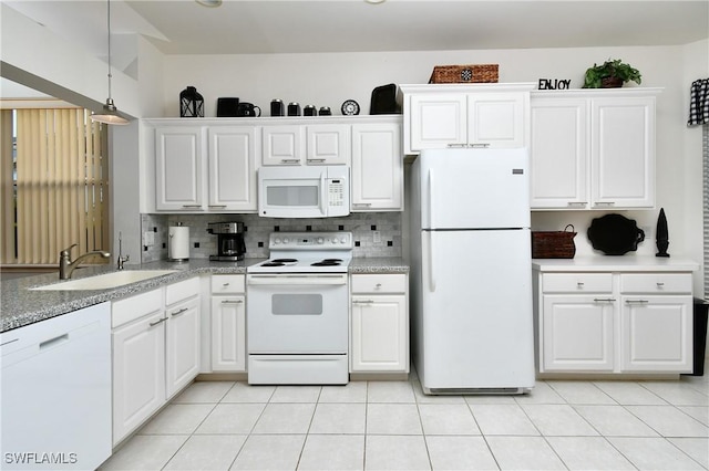 kitchen with white appliances, a sink, white cabinetry, and decorative backsplash